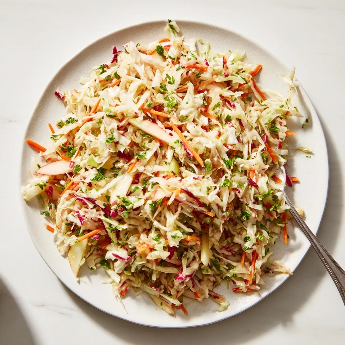 Refreshing sauerkraut and apple slaw, garnished with fresh herbs and vibrant colors.  